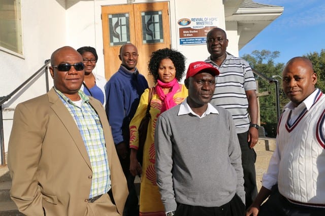 Photo of seven people in front of church.