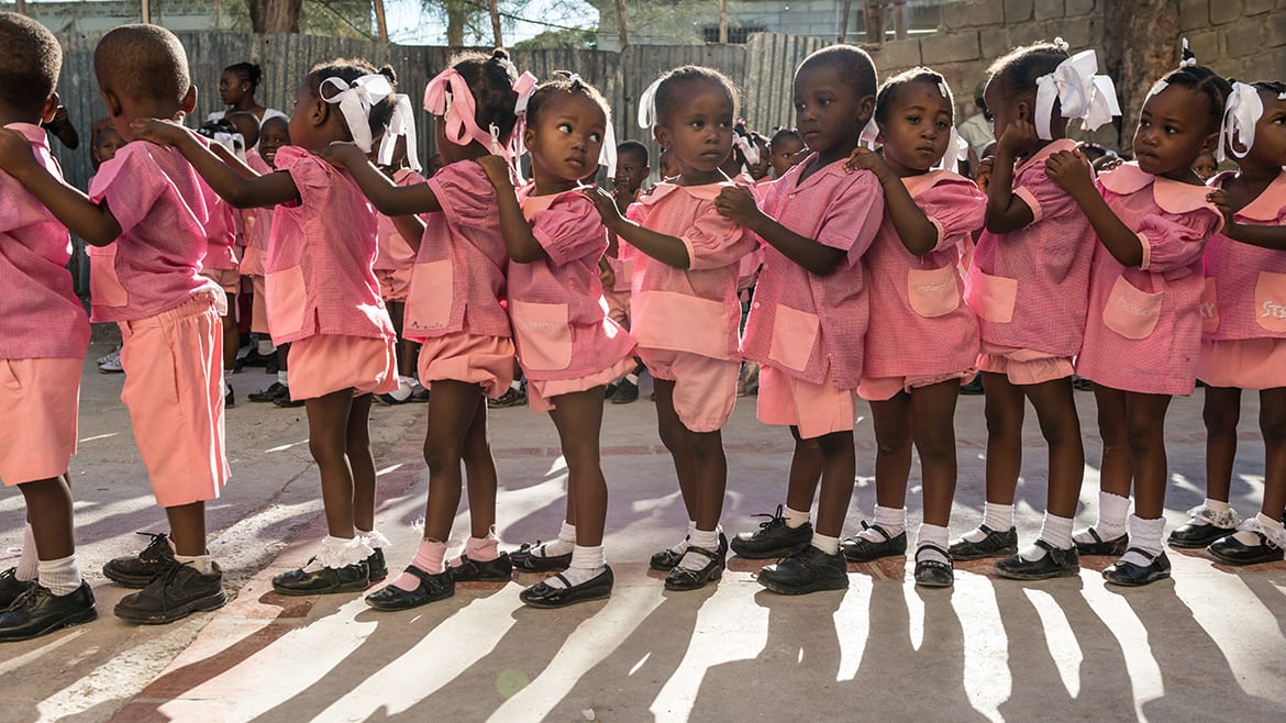 Image from "A Path Appears" of little girls standing in a line.