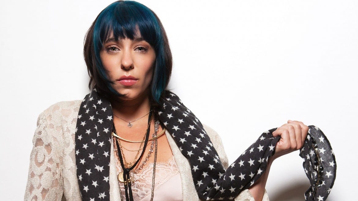 woman w/ blue and black hair poses for the camera