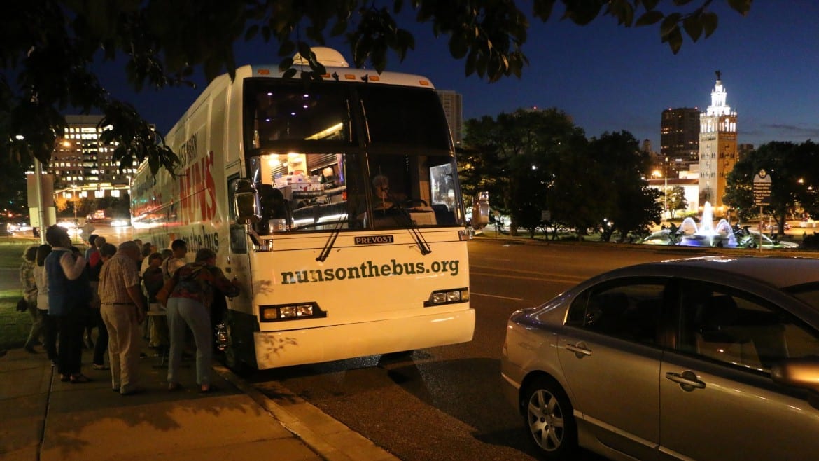 people signing tour bus