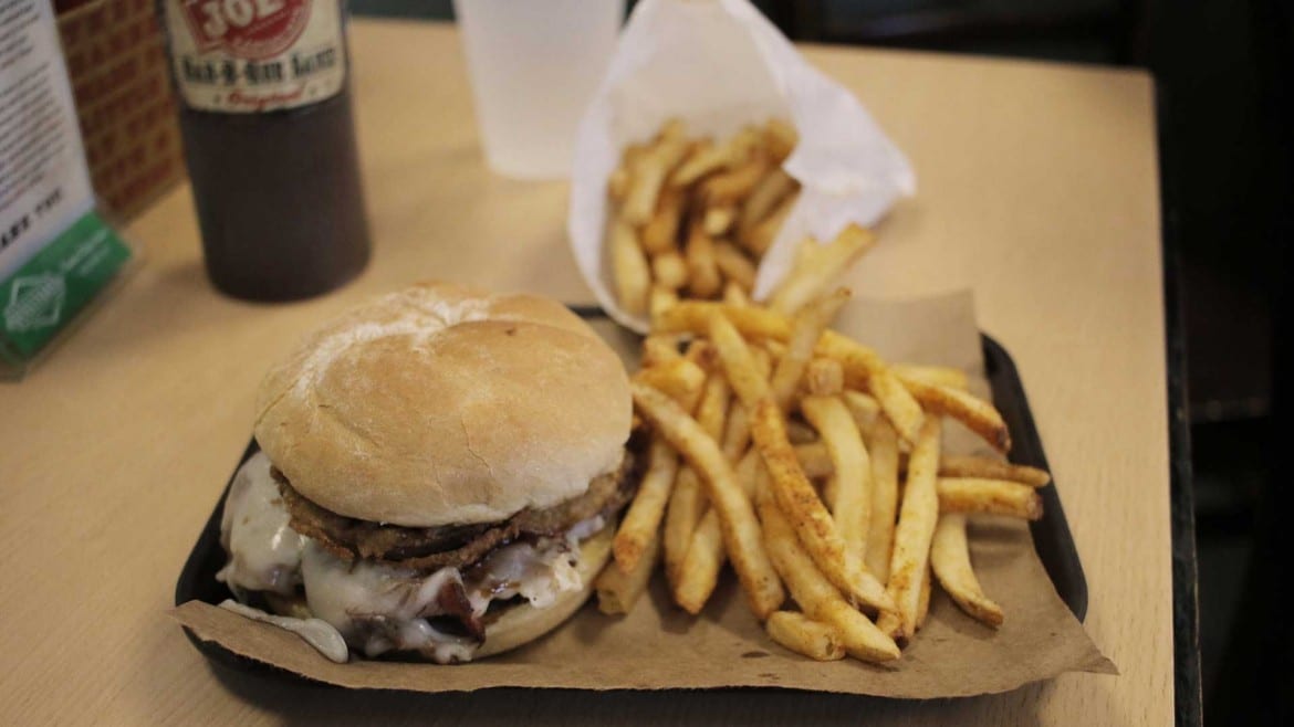 The Z-man combines smoked brisket, onion rings, smoked provolone, and barbecue sauce on a toasted egg bun. (Photos: Cole Blaise | Flatland)