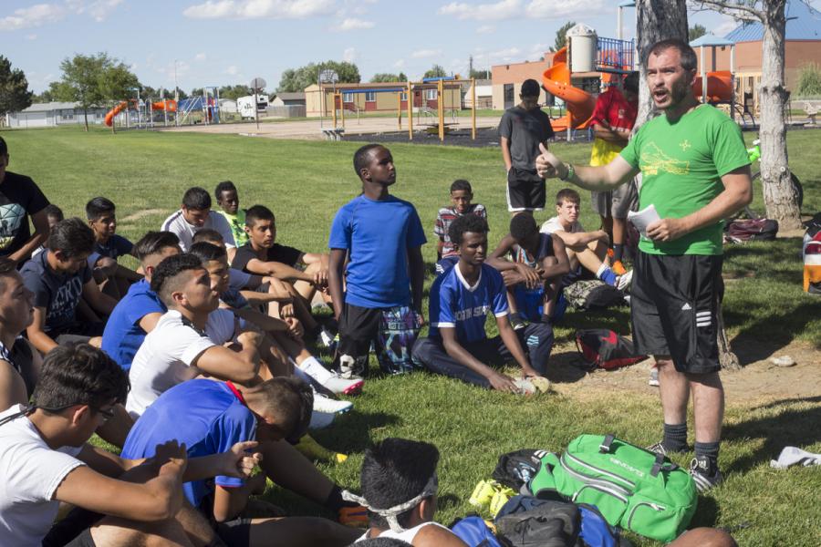Coach Nick Ng calls roll at one of the first practices for the Fort Morgan High School Mustangs. (Photos: Poncie Rutsch | Harvest Public Media)
