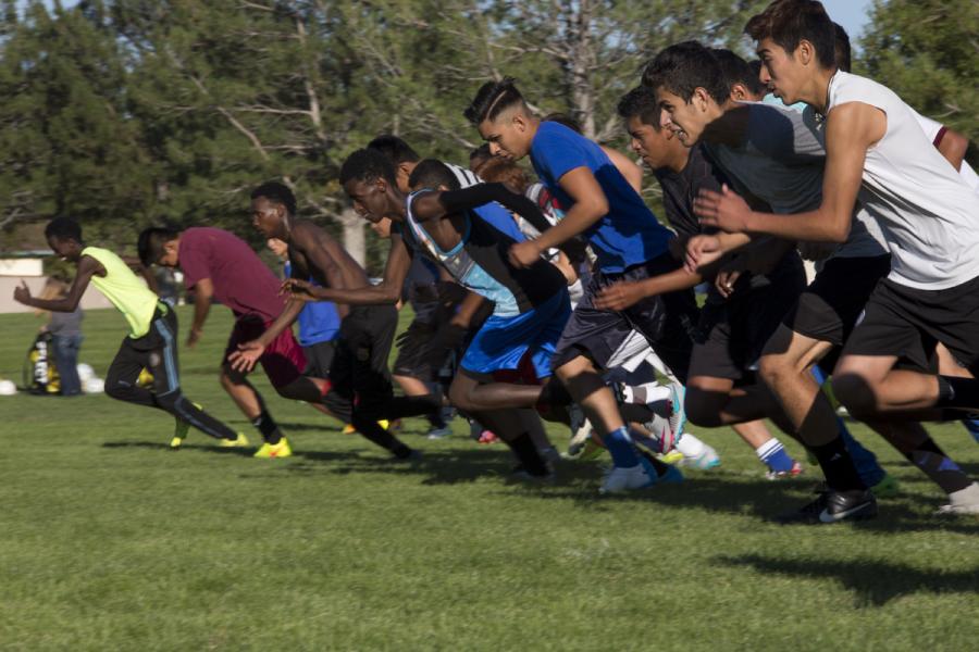 The Fort Morgan Mustangs run a stride, or one length of the soccer field, for each player late to practice. (Photo: Poncie Rutsch | Harvest Public Media)