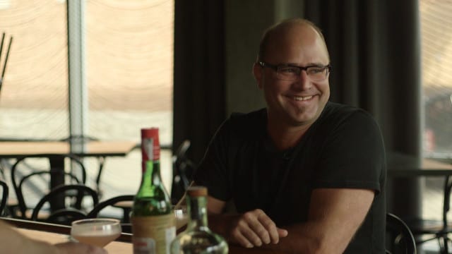 A fan of the "Papa Doble," chocolatier Christopher Elbow sits down with Julep's owner, Beau Williams, to talk over the frothy cocktail. (Photo: Cole Blaise | Flatland)
