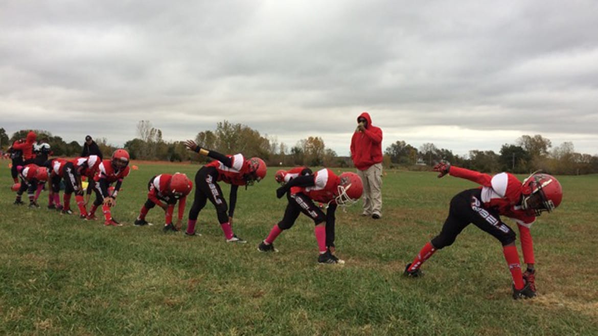 The KC United league plays weekly games in an empty field next to a church in western Kansas City, Kansas. (Photo: Alex Smith | Heartland Health Monitor)