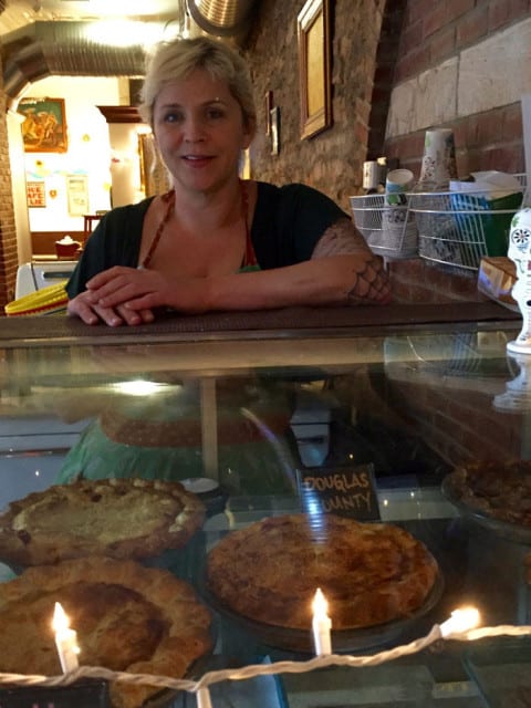 Woman in front of pie case
