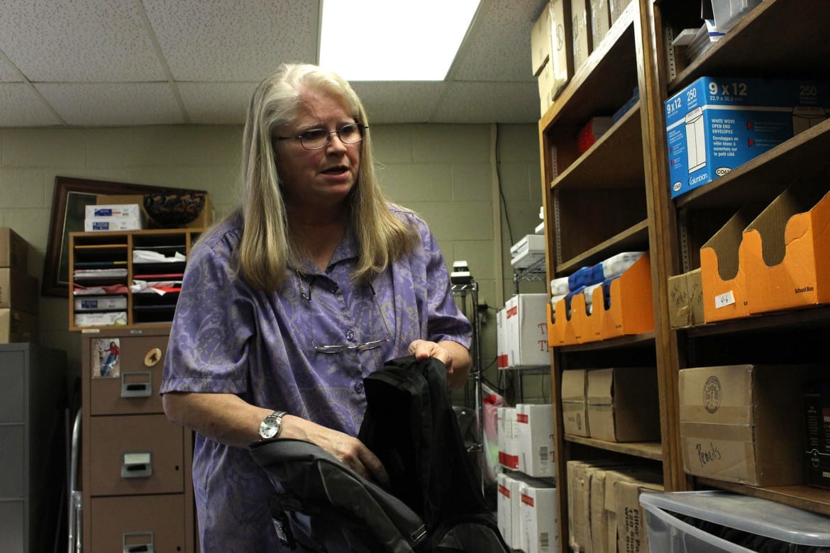 Sara Carrillo prepares a backpack with free school supplies.