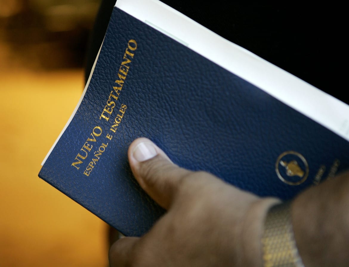 George Diaz holds a bilingual Bible as he attends services in Louisville, Ky. Services at the chapel are delivered in both English and Spanish. (Photo: Ed Reinke |AP)