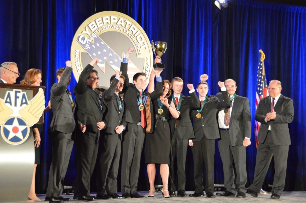 Team hoisting trophy