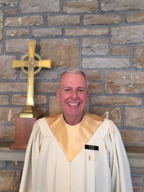 A man in front of a cross