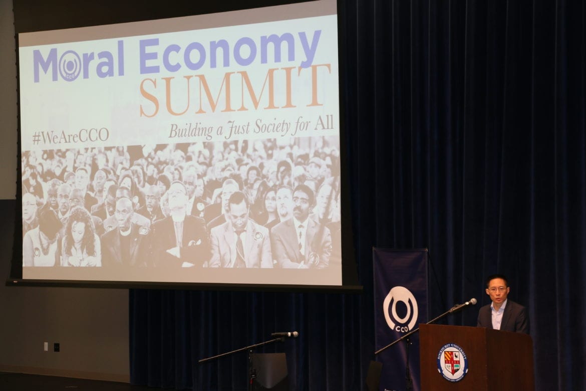 A man speaking in front of a power point presentation