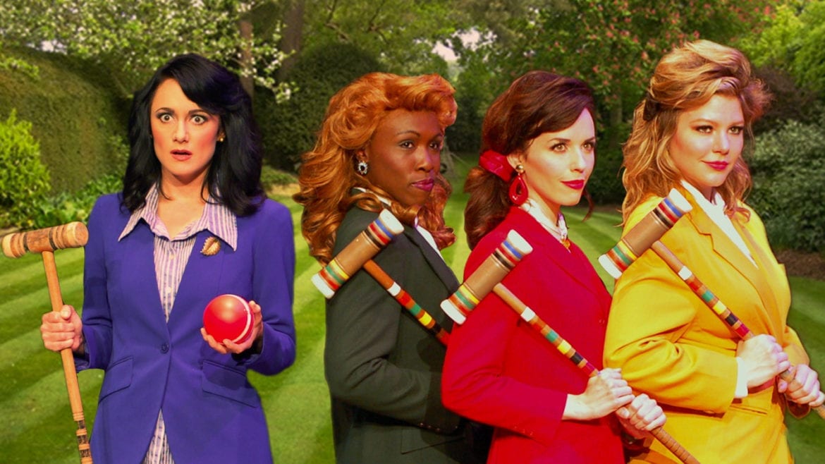 4 women playing croquet