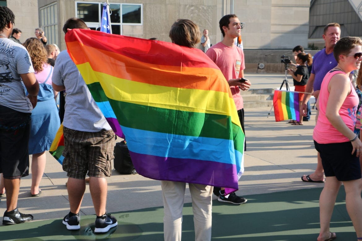 A person with a rainbow Pride flag.