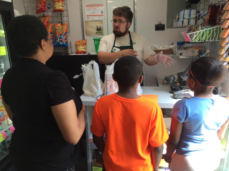 Rolling Grocer employee talking to customers