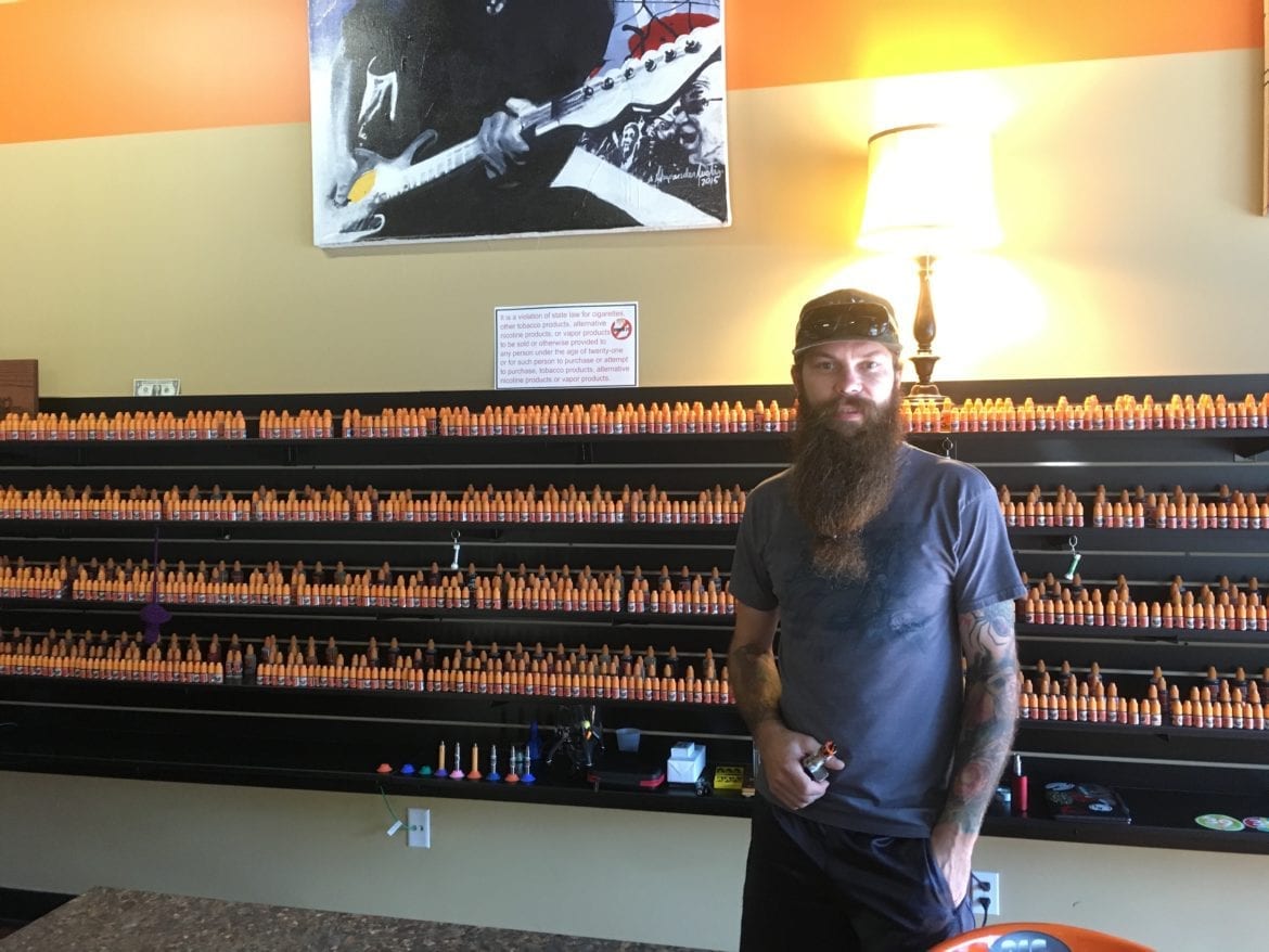 A man in front of store display