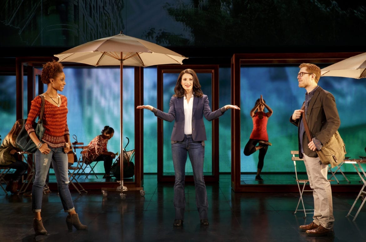 A woman stands on a stage.