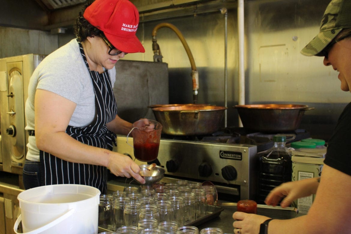 A woman filling jars.
