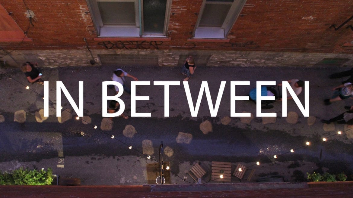 Image of an alley with words In Between written on it