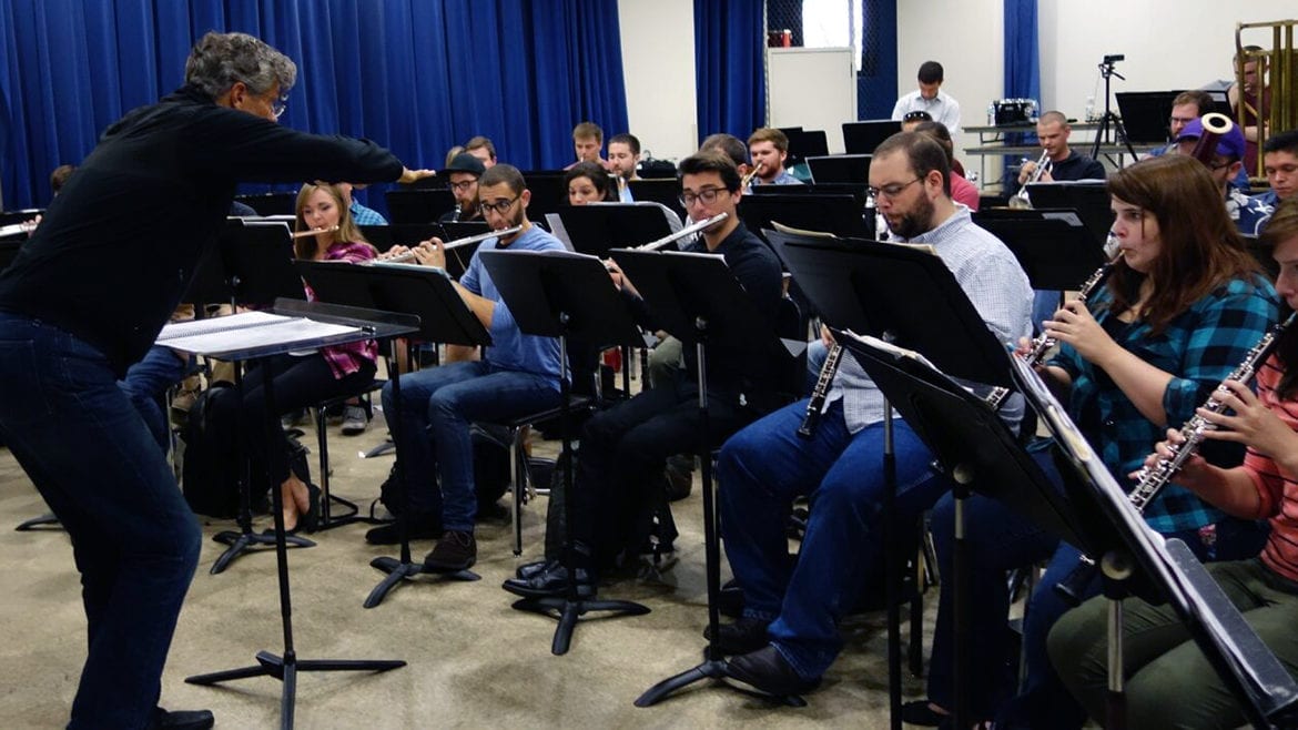 A conductor and student wind ensemble