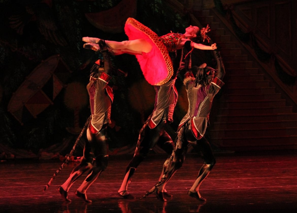 A ballerina being held in the air.