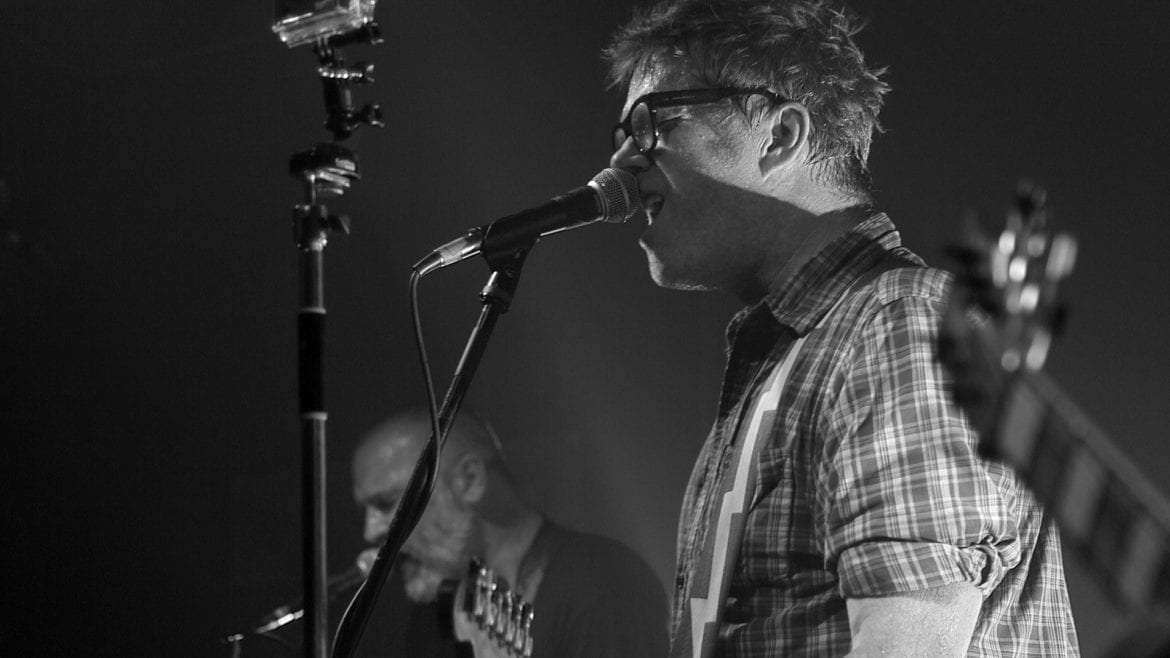 A man singing on stage.