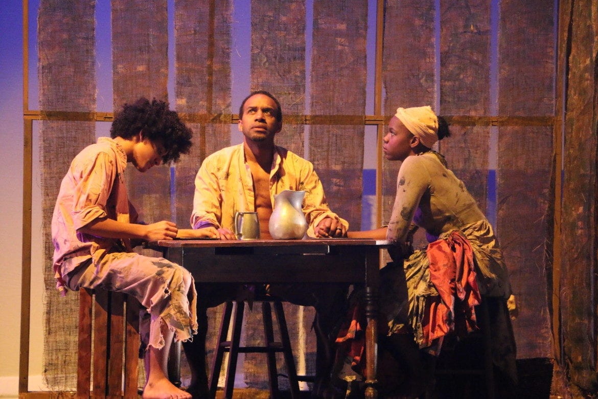 Three individuals on stage.