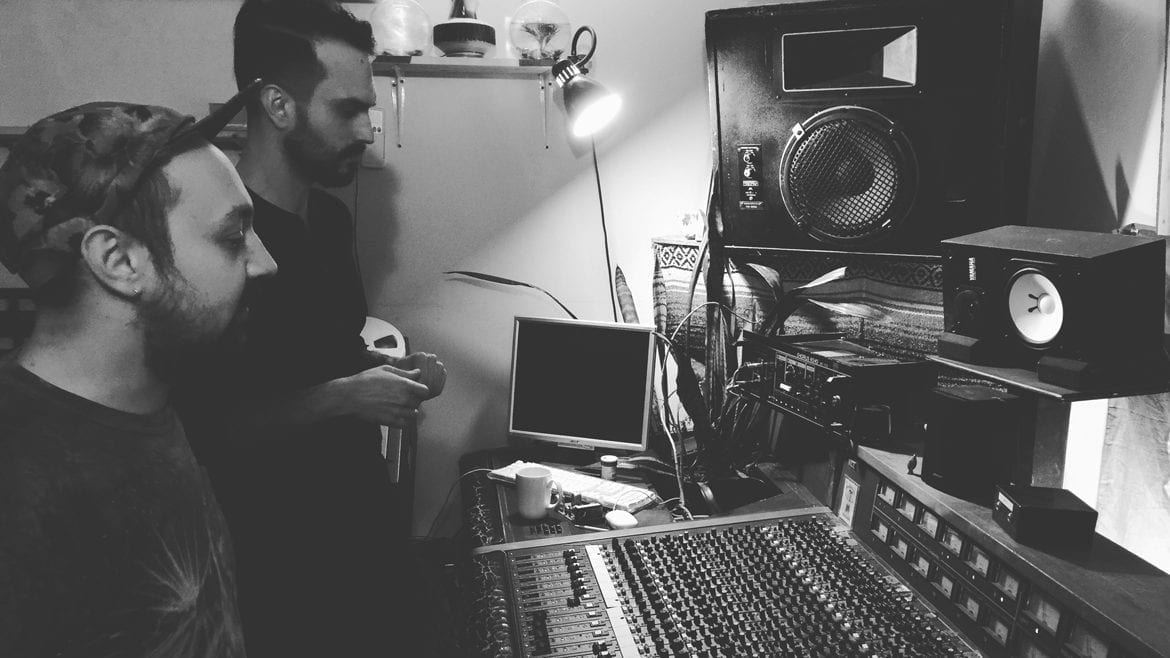 Musician and sound engineer at mixing board