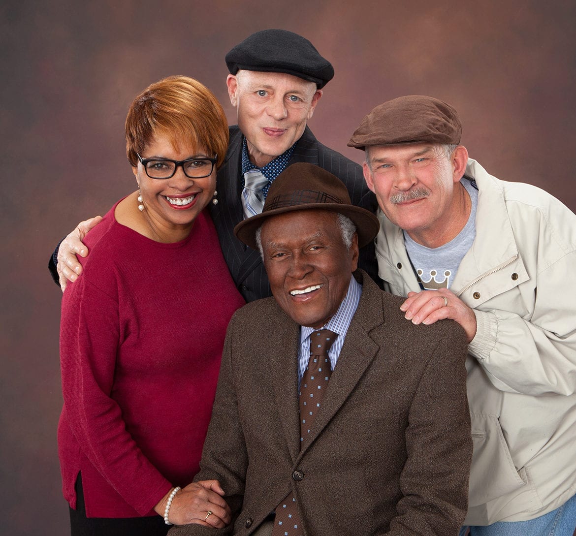 three former students surround Alvin Brooks in a portrait