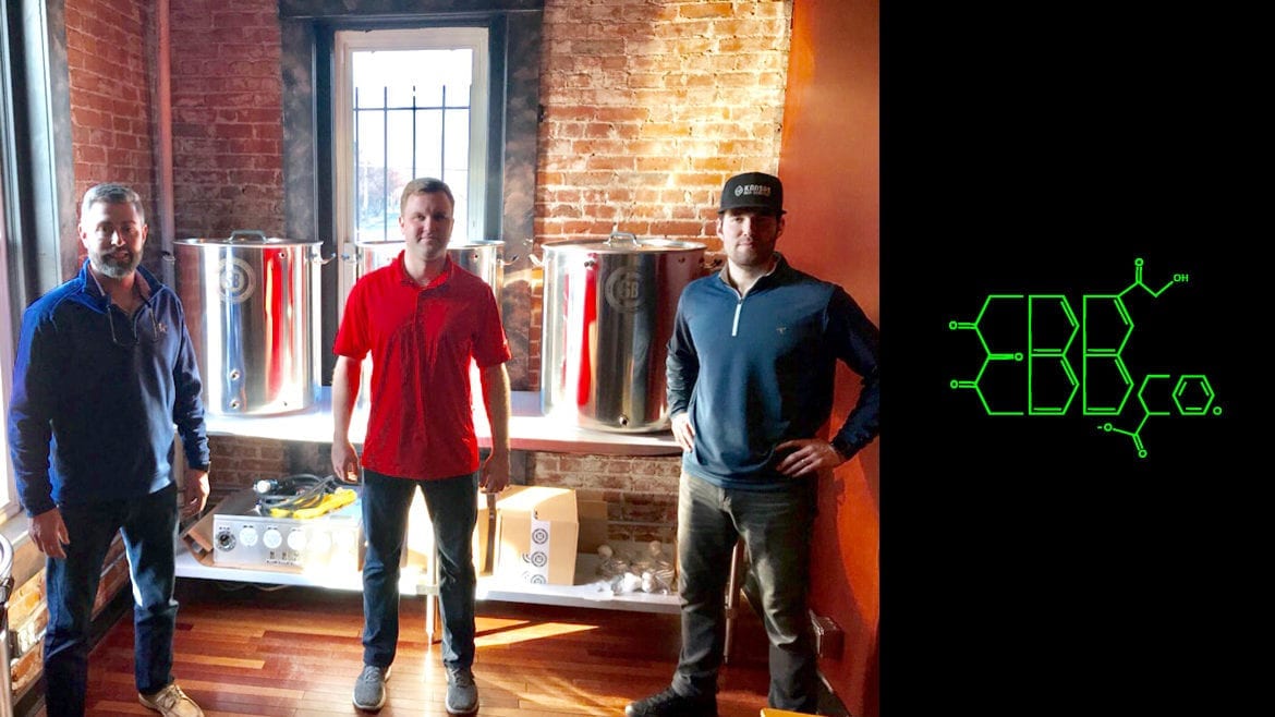 three men standing in a room