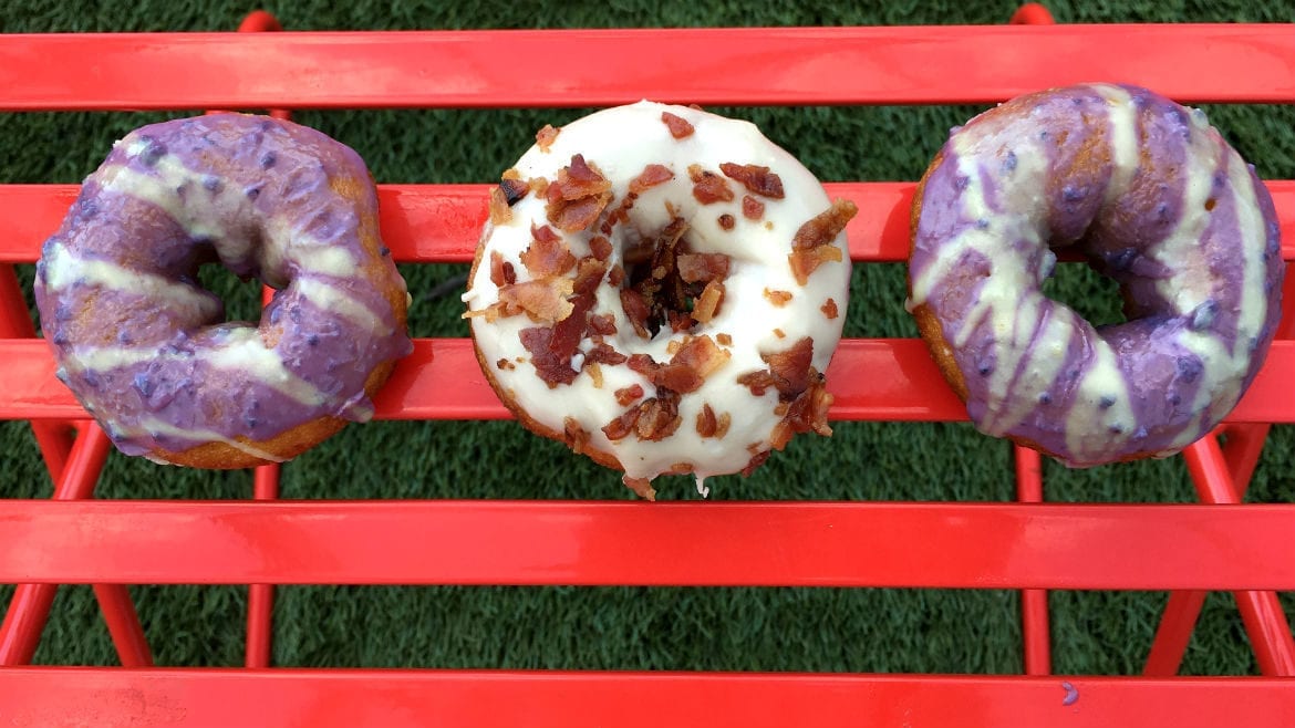 three colorful donuts on a table