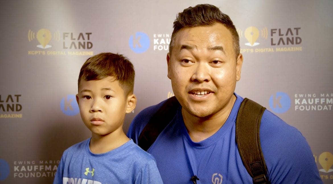 a man and his son talking on camera