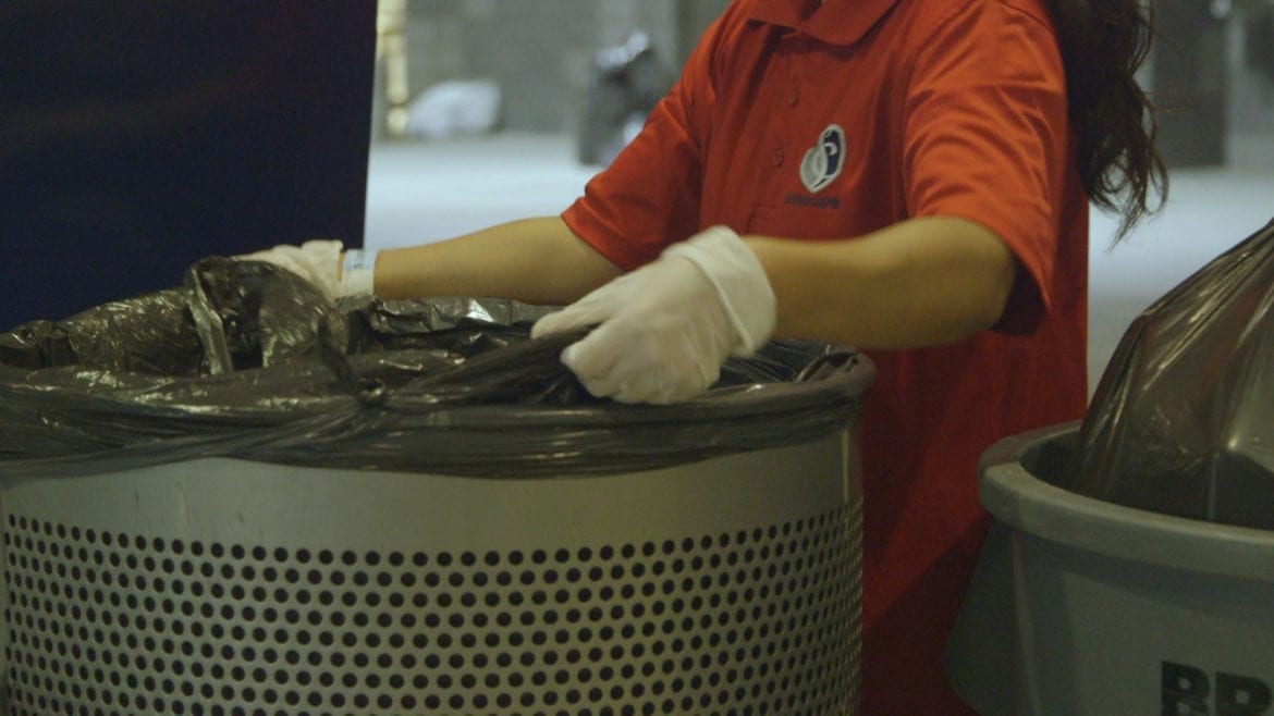 worker changing trash bag at children's mercy park in Kansas City, Kansas