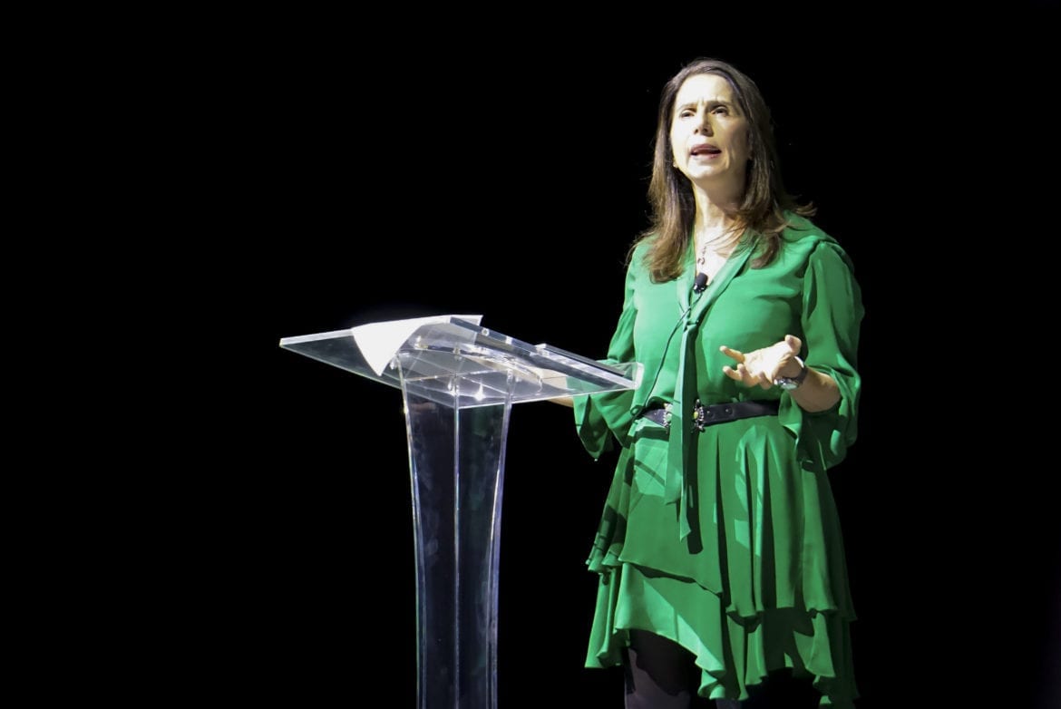 A woman speaking at a podium.