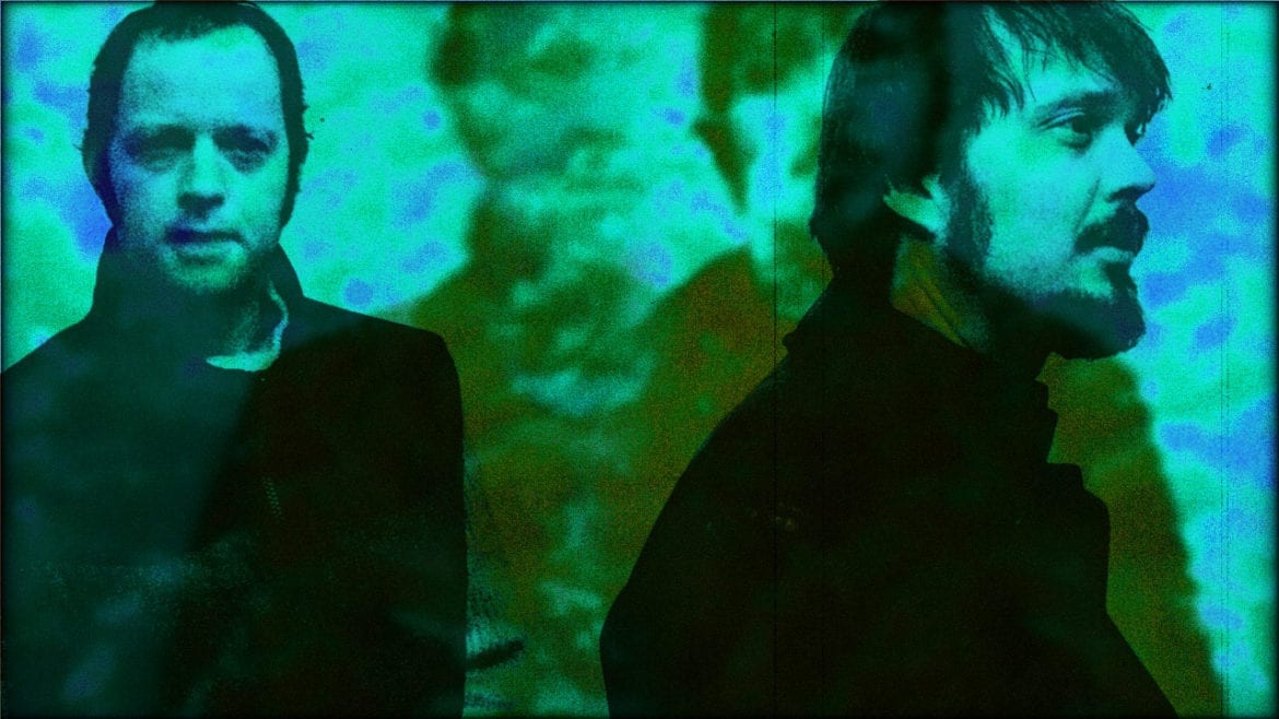 An artistic, blue-toned image of two men