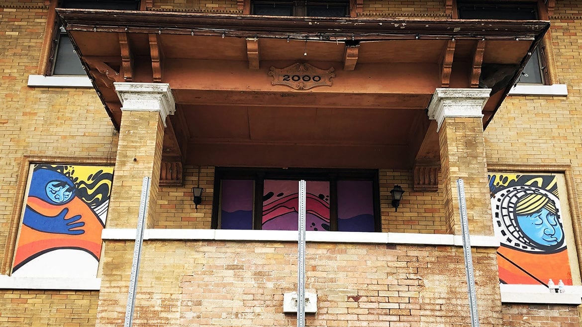 Murals cover the windows at the front of the Rector House