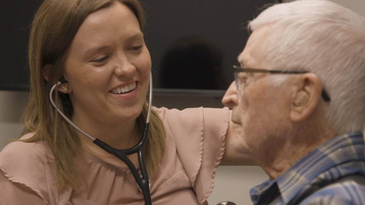 A medical student examines a patient