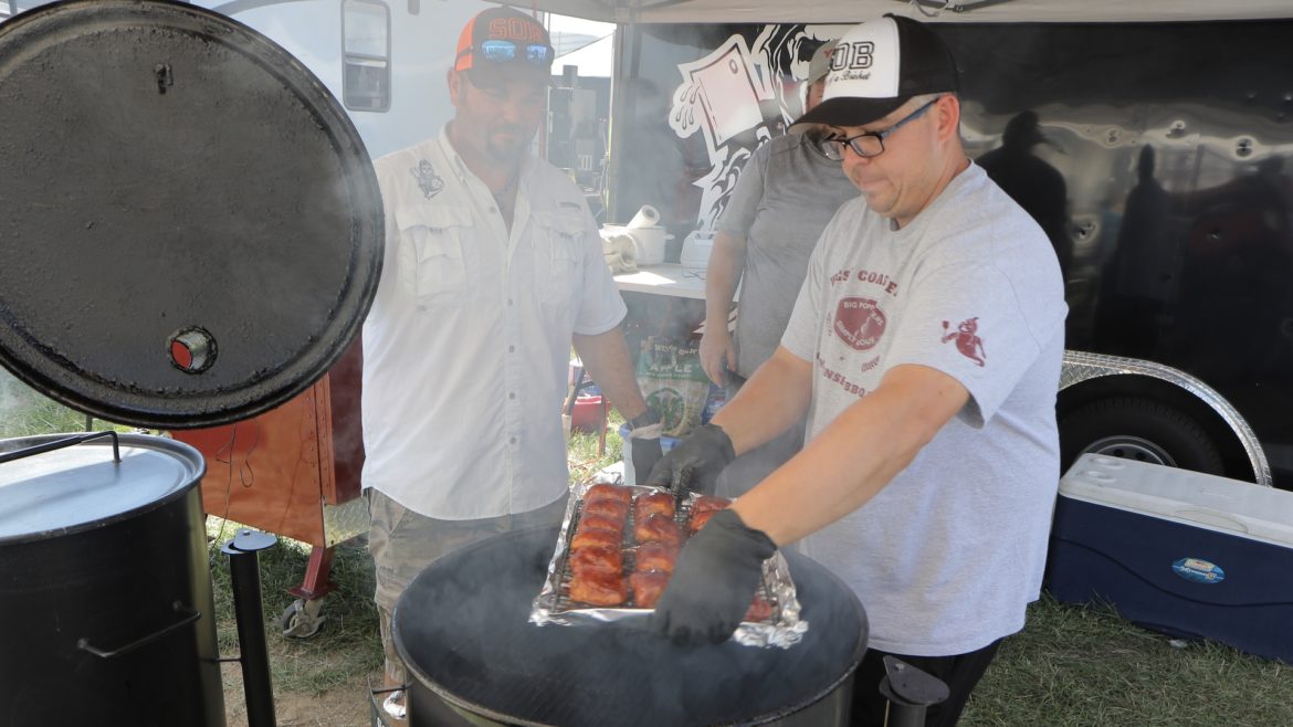A man reveals his tray of barbecue.