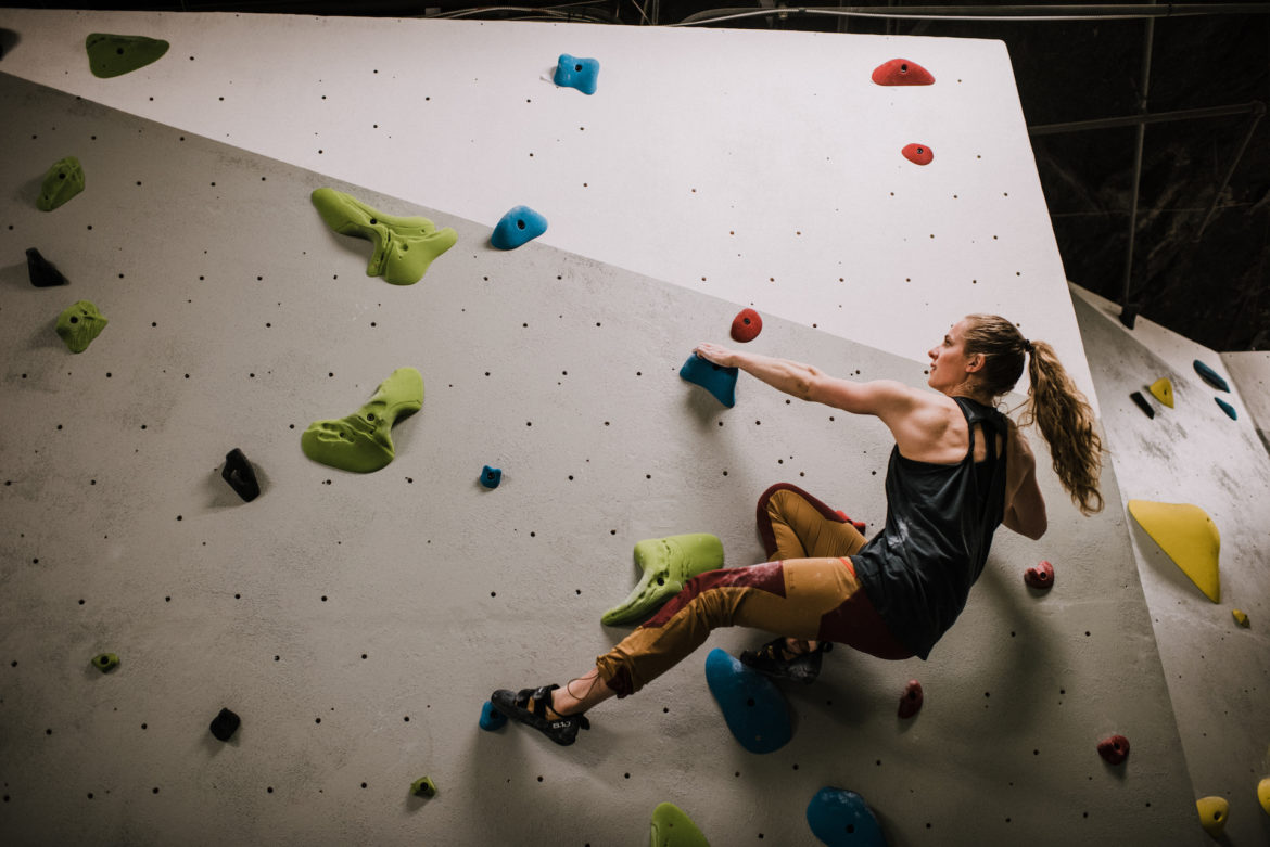 A climber reaches for the next hold.
