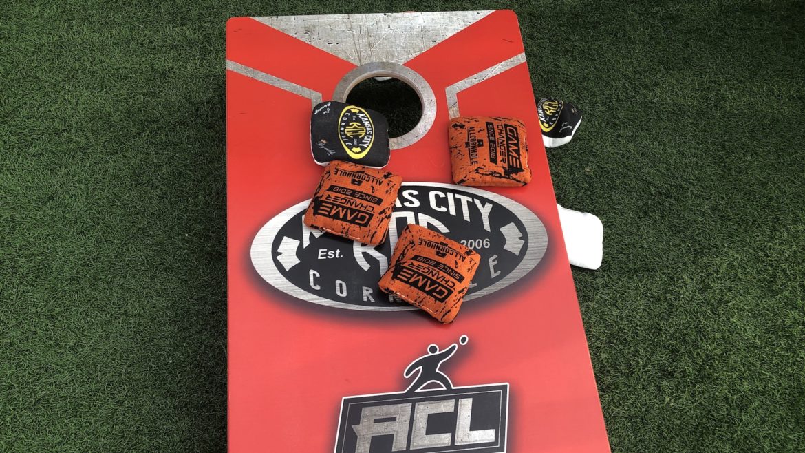 A cornhole board is covered with bean bags.