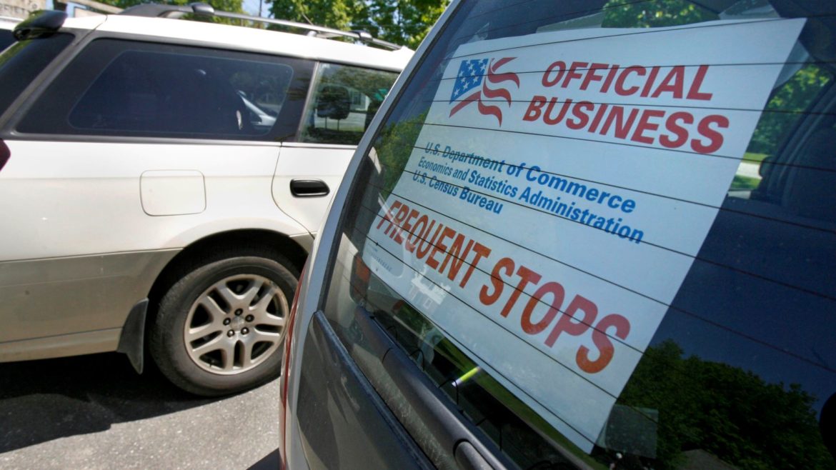 A sign marks the vehicle of a census enumerator.