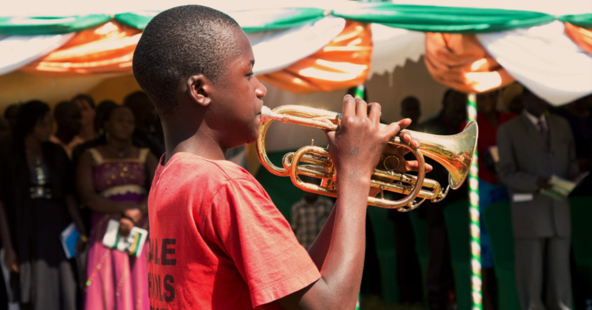 Kid playing a trumpet