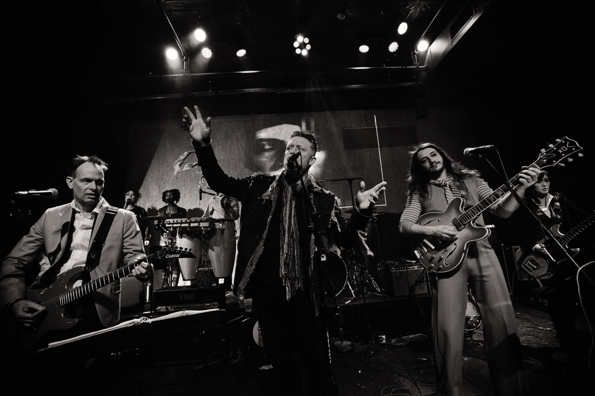 The Band That Fell to Earth plays music on stage.