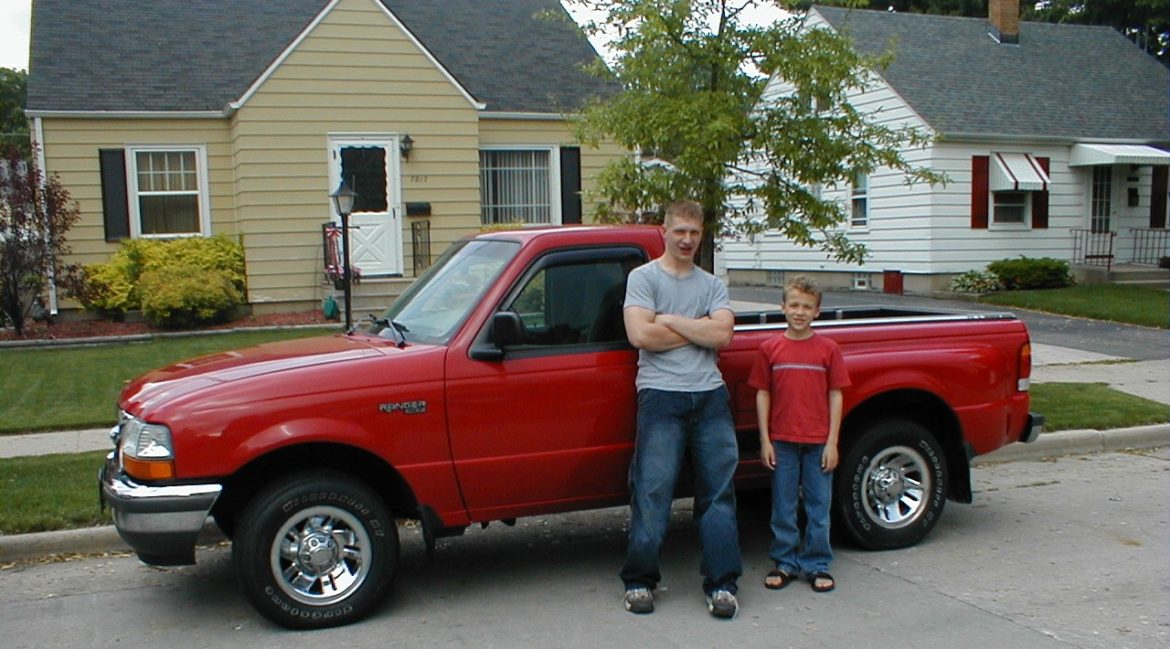 Michael Bell Jr. stands in front of his pickup truck with his younger brother, Taylor.