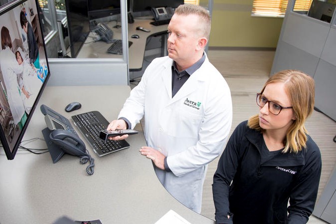 Brian Skow, an emergency room specialist, and nurse Amanda Sandager respond to a video call at Avera eCARE telemedicine center in Sioux Falls, South Dakota.
