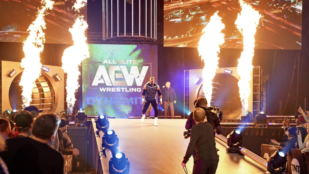 A wrestler enters the arena to flame throwers.