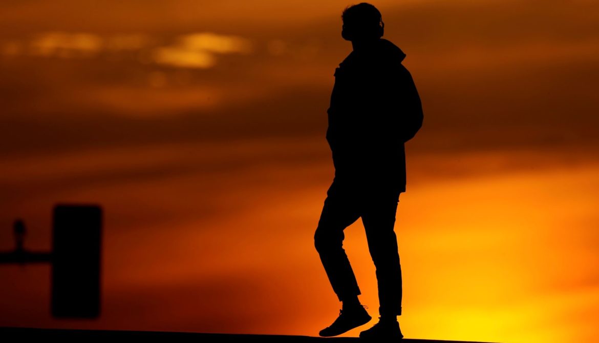 A person crosses a downtown street in Kansas City.