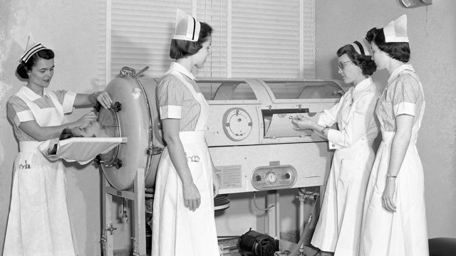 Nurses at the University of Kansas Medical Center demonstrated the use of a tank respirator, or “iron lung,” for polio patients in 1950.
