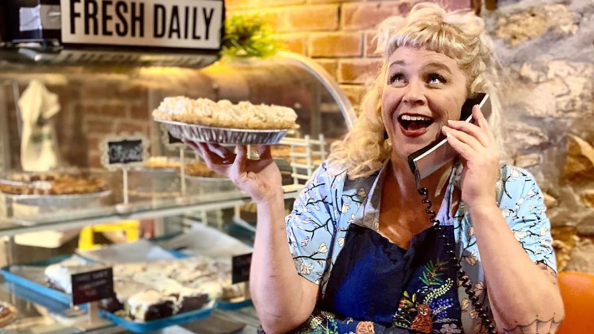 Meg Heriford, owner of Ladybird Diner, holds a pie and poses