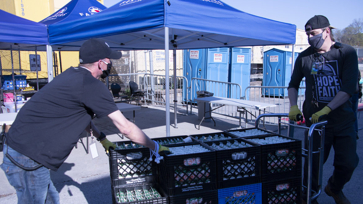 two hope faith staffers wheel in some donated orange juice