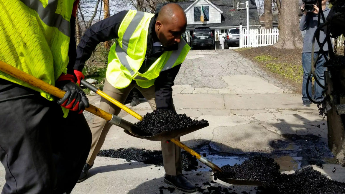 Quinton Lucas shovels asphalt